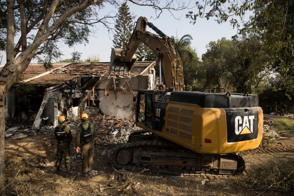 Members of Army rescue crews search for bodies and body parts after the Hamas attack on the Kibbutz