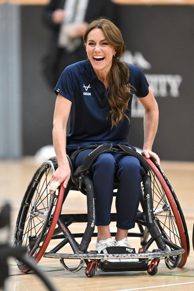 Kate was all smiles as she tried her hand at the sport - with her fingers strapped up