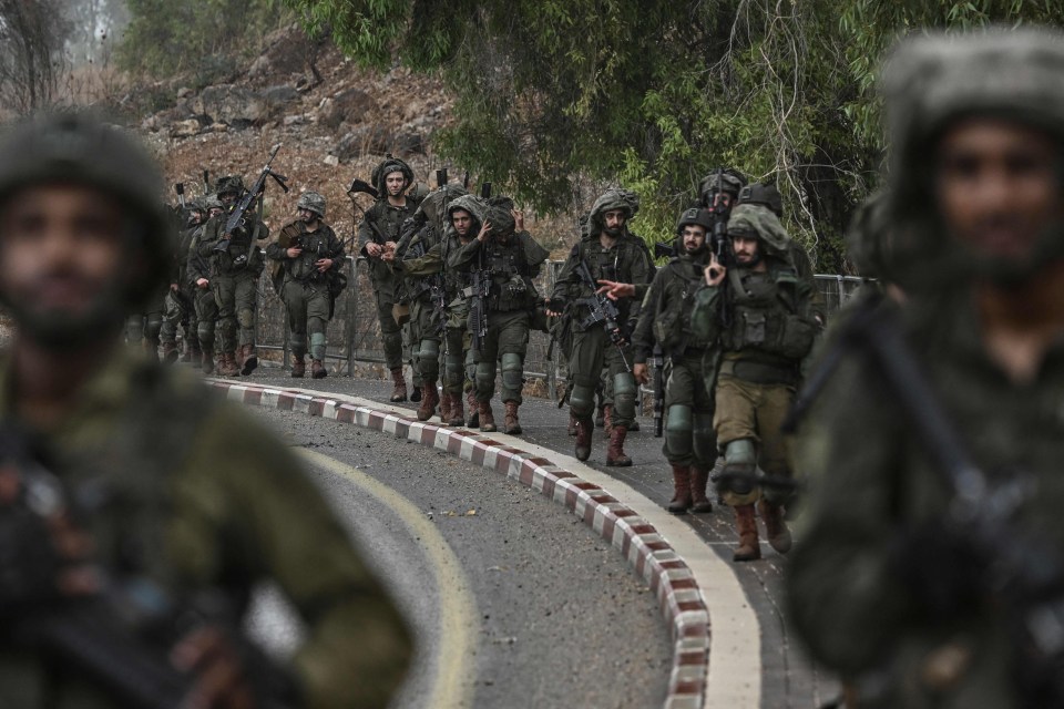 Israeli army soldiers patrol an undisclosed position near the border with Lebanon