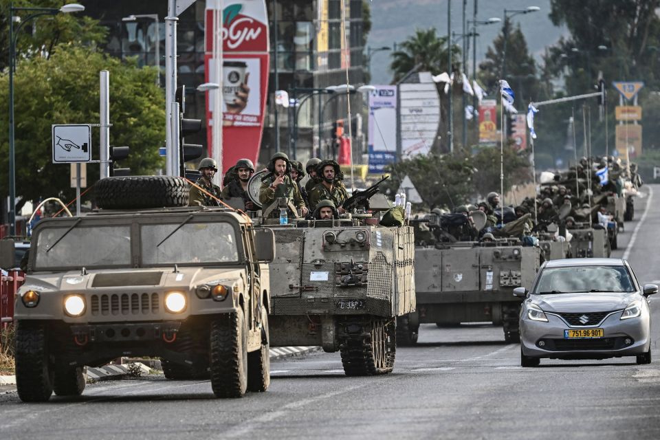 Israeli soldiers patrol in armoured personnel carriers in northern Israel near the border with Lebanon