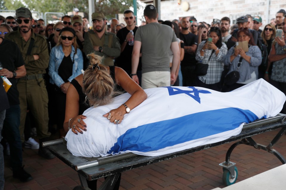 Family members mourn at the funeral of festival victim Antonio Macias in the Pardes Chaim cemetery in Kfar Saba, Israel