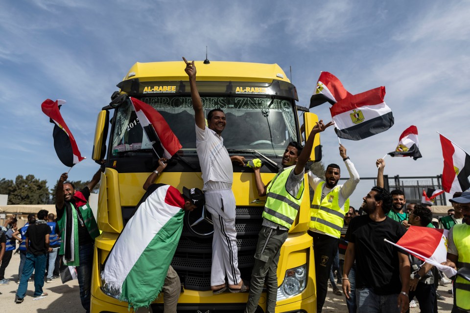 Volunteers celebrate after unloading aid supplies for Palestine