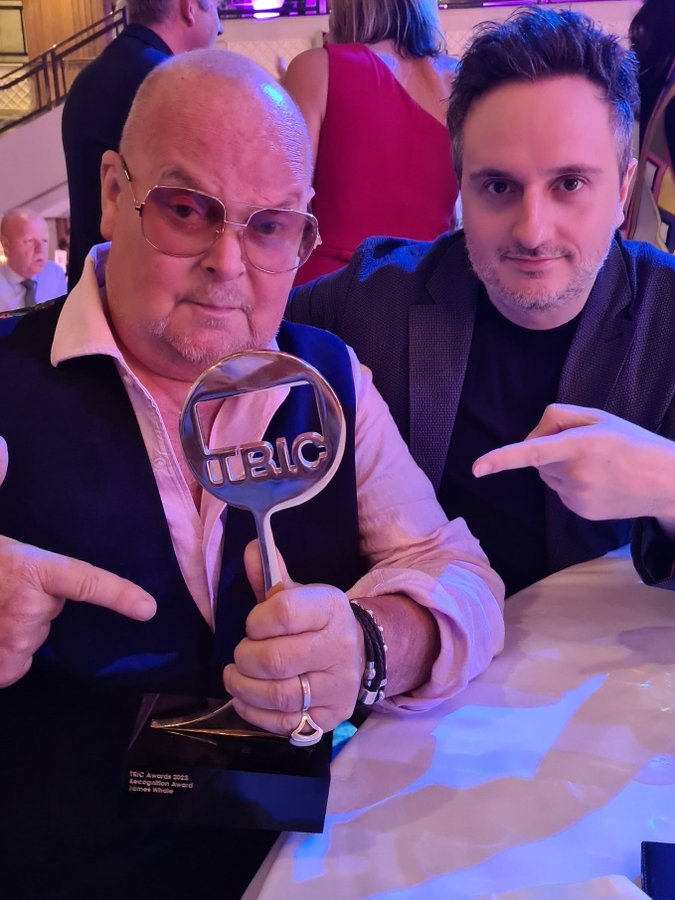 Award-winning presenter James with his producer at the TRIC awards do