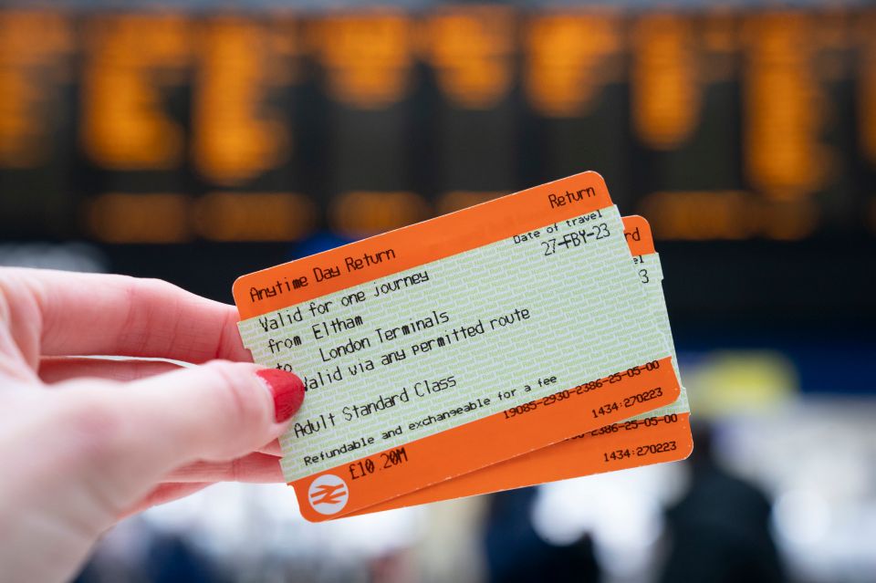 a person holding a ticket that says anytime day return