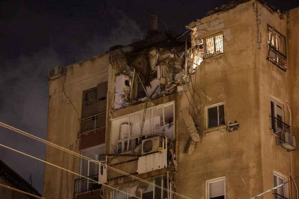 A building in Tel Aviv is damaged by a rocket fired by Hamas