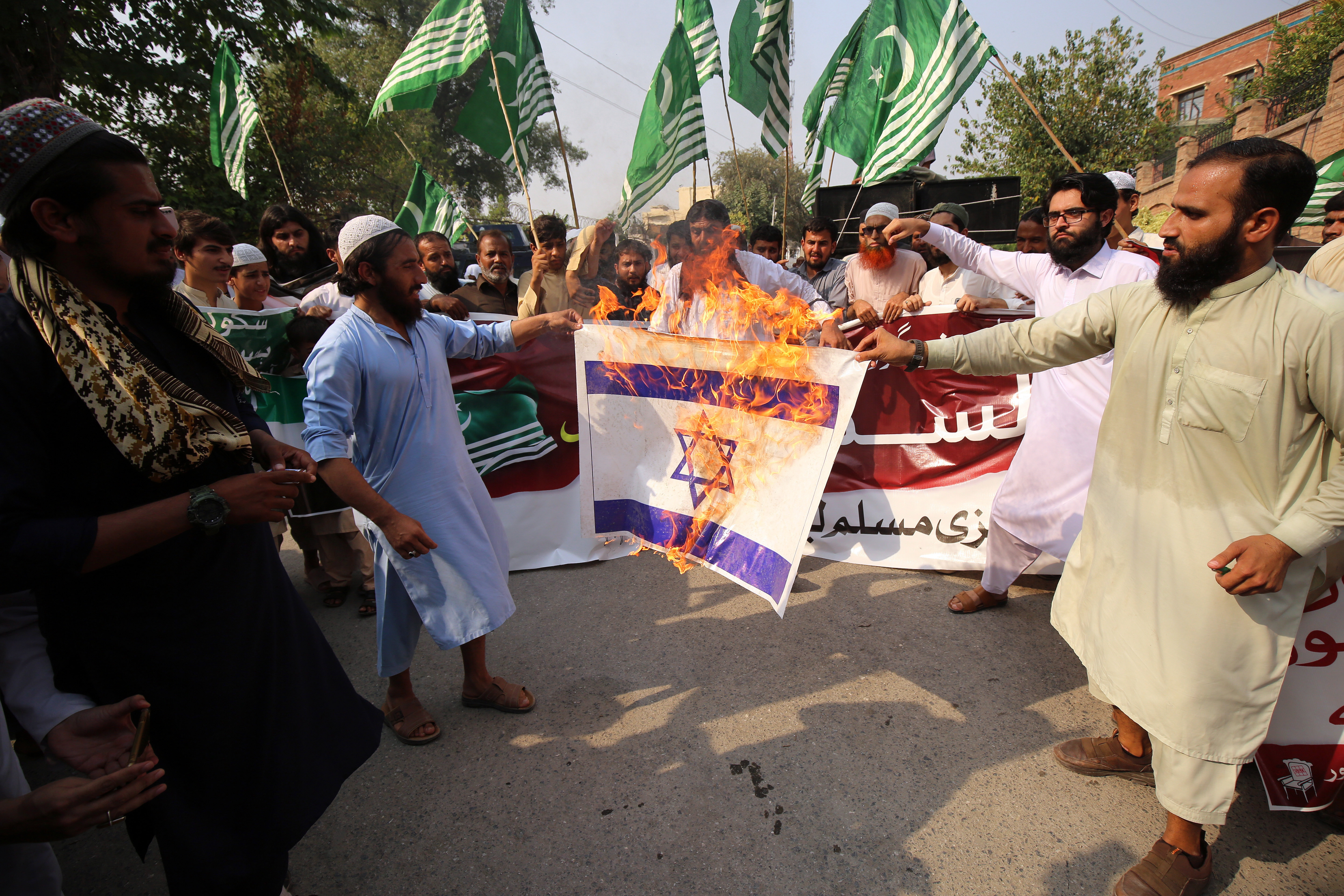 Protesters burn an Israeli flag in Pakistan on the so-called 'Day of Jihad'