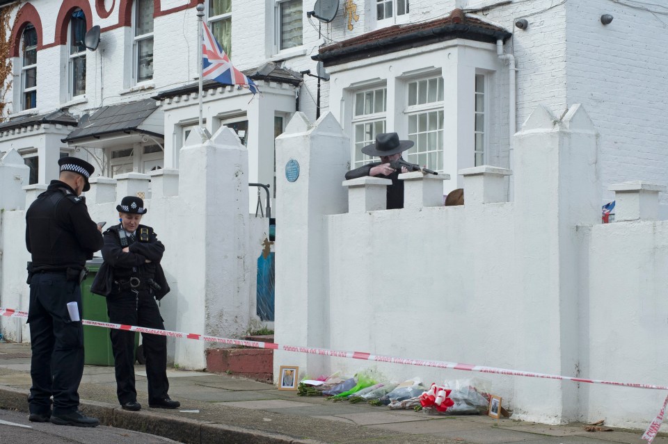 Officers guard a police cordon around Dave's home on Monday