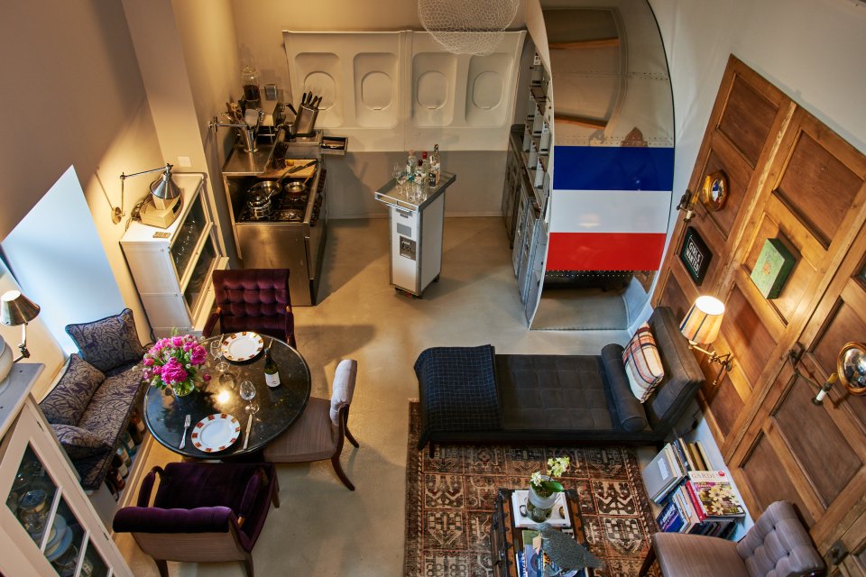 The open-plan kitchen features a galley from a Boeing 737 aeroplane