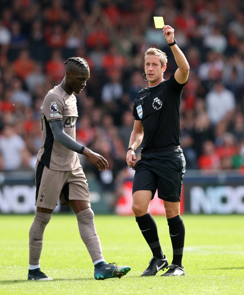 Yves Bissouma receives a yellow card in Tottenham's clash with Luton Town