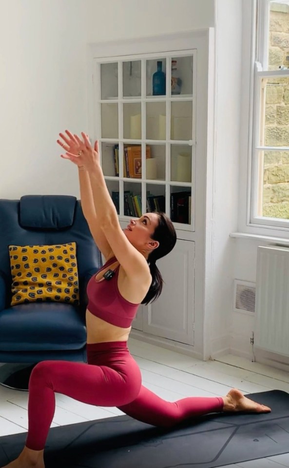 Her lounge room with white floorboards and exposed brick fireplace plays host to many of her videos