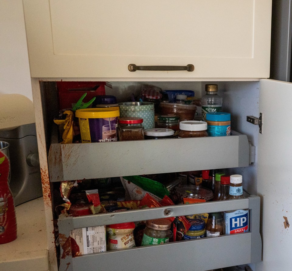 The kitchen and dining area was littered with bloodied debris and bullet casings