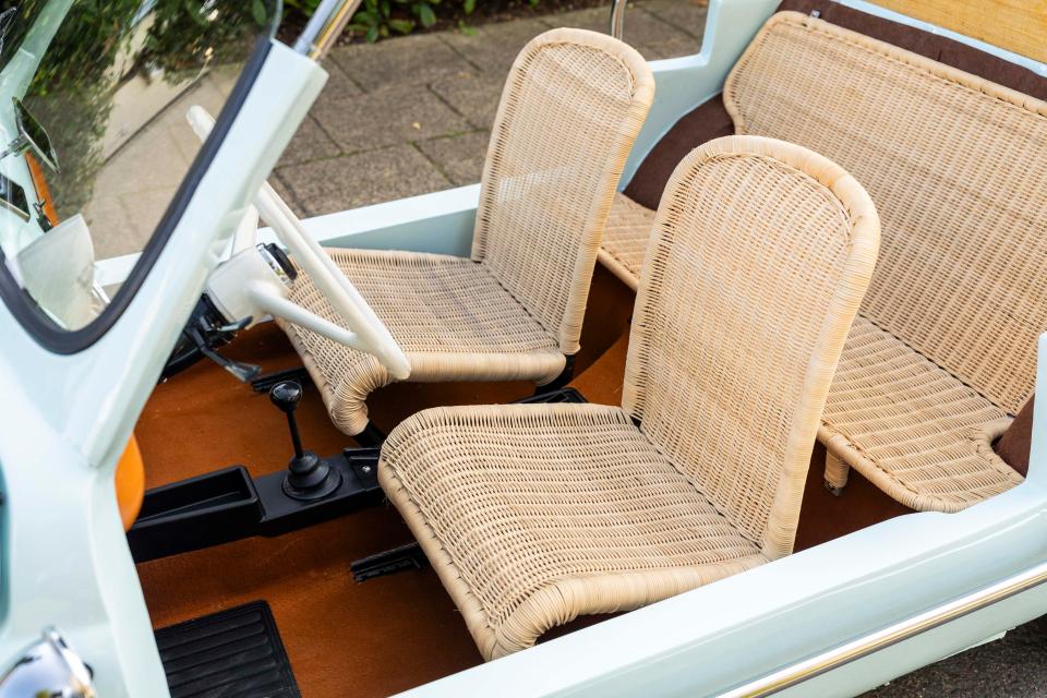 The little motor is heavily modified, with wicker seats and an open top