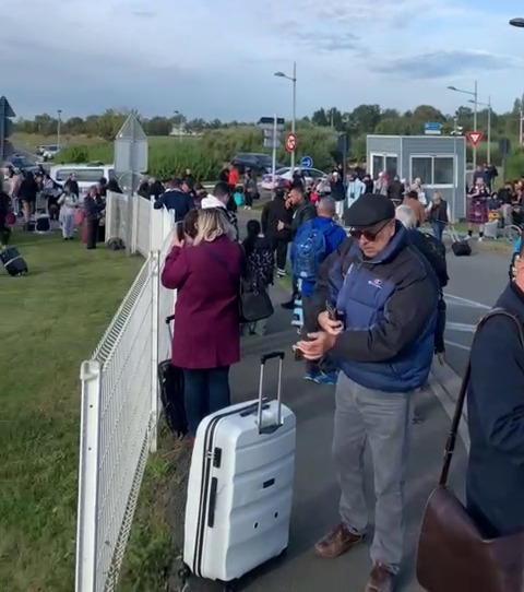 Passengers in Lille wait outside the airport after the bomb scare