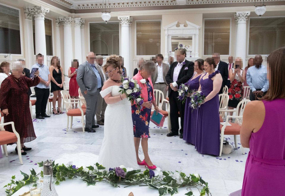 The bride walks down the aisle with mum Barbara