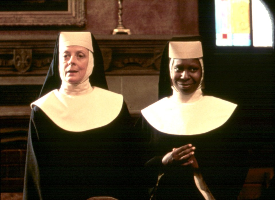 two nuns are standing next to each other in a room