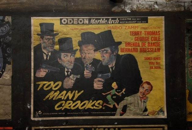 A film poster featuring Terry Thomas and a young Sid James