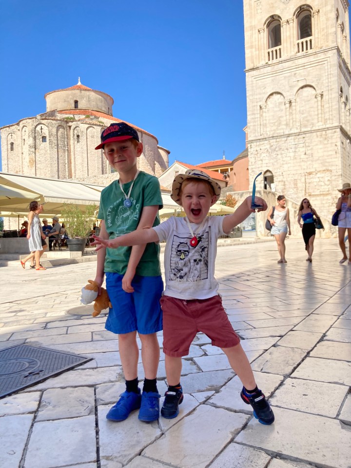 Ralph, 7, and Max, 4, in Croatia, with Airtags around their necks