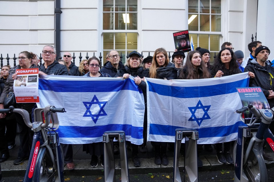 Demonstrators hold flags of Israel as they form a human chain outside the Qatar embassy in a protest calling for the release of the Israeli hostages being held by Hamas in London, Britain, October 29, 2023. REUTERS/Maja Smiejkowska