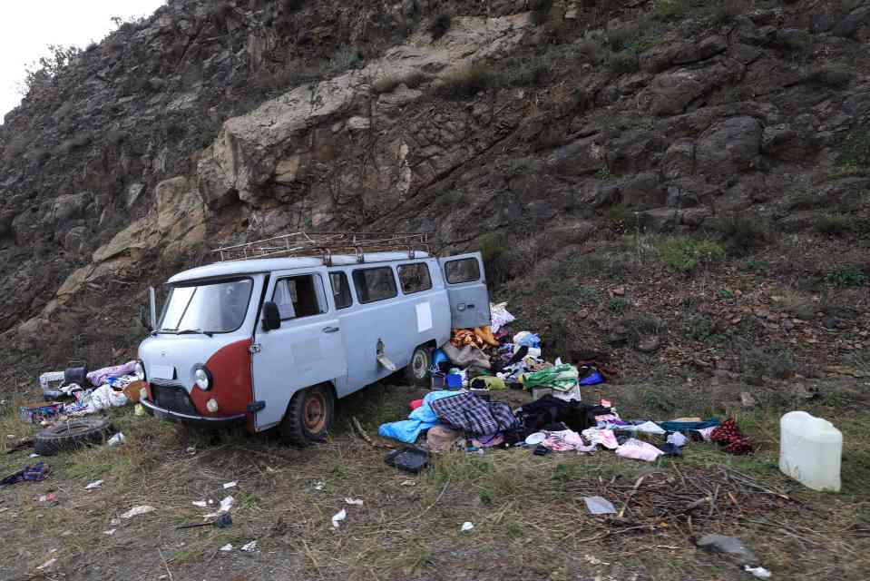 An abandoned mini van left by fleeing Armenians is seen on the side of a road