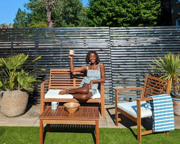 Her beautiful garden boasts a black fence and pristine lawn