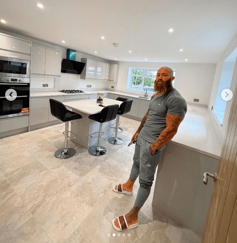 Ashley poses in his gleaming and modern kitchen