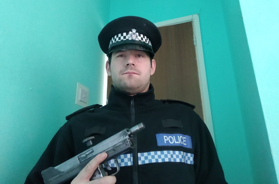 The 32-year-old posing in a police uniform with a weapon