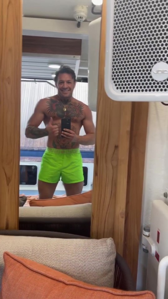 McGregor posed in green shorts while taking a mirror selfie