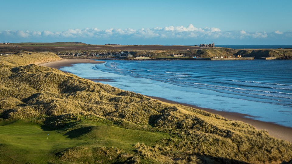 The castle can be seen overlooking the bay from the top of a cliff