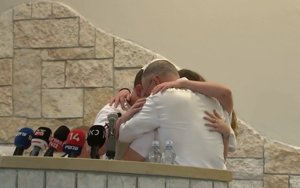 The family embrace during the funeral which drew in thousands from across Israel