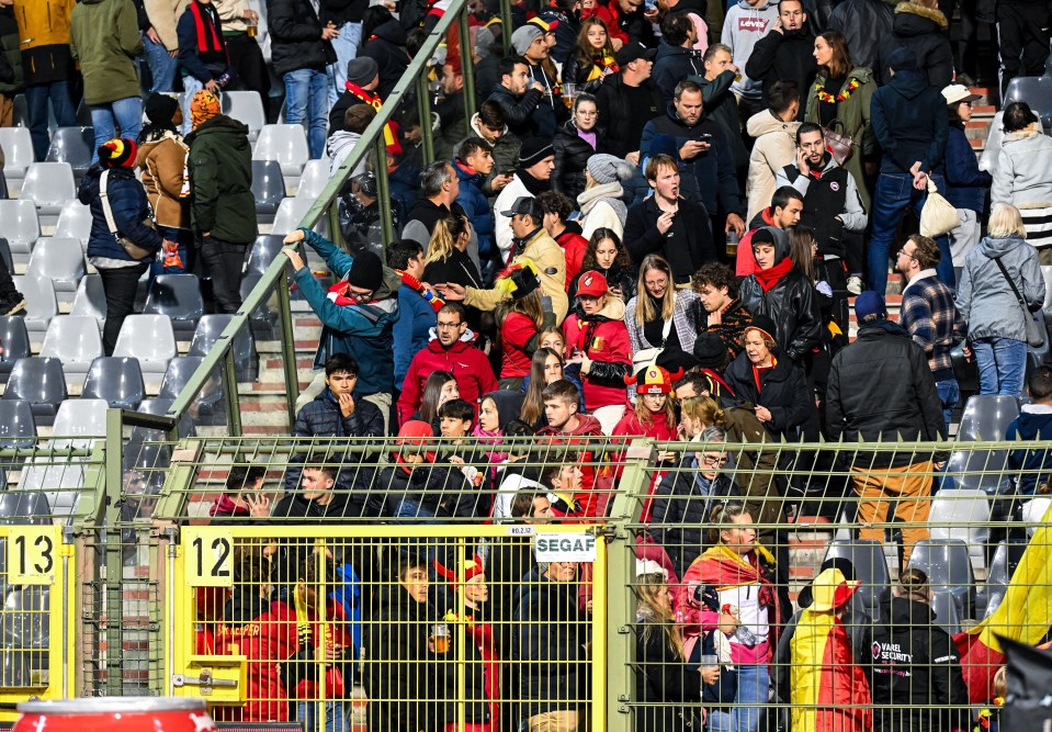 Belgium fans fleeing the stadium after the match was called off