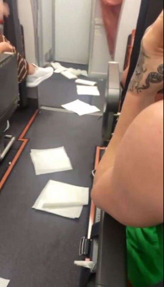 Toilet paper was left strewn across the walkway of the plane