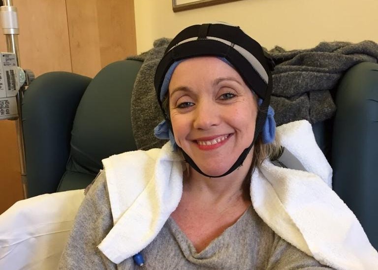 Emma having chemotherapy, wearing a cool cap to help prevent hair loss