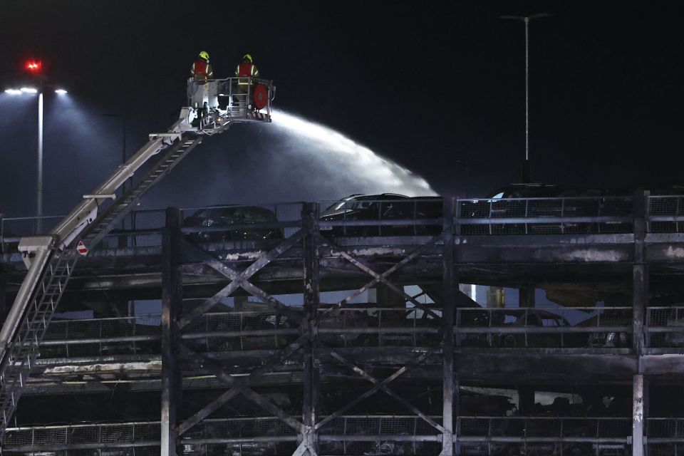 Firemen battled the blaze at London's Luton Airport last night