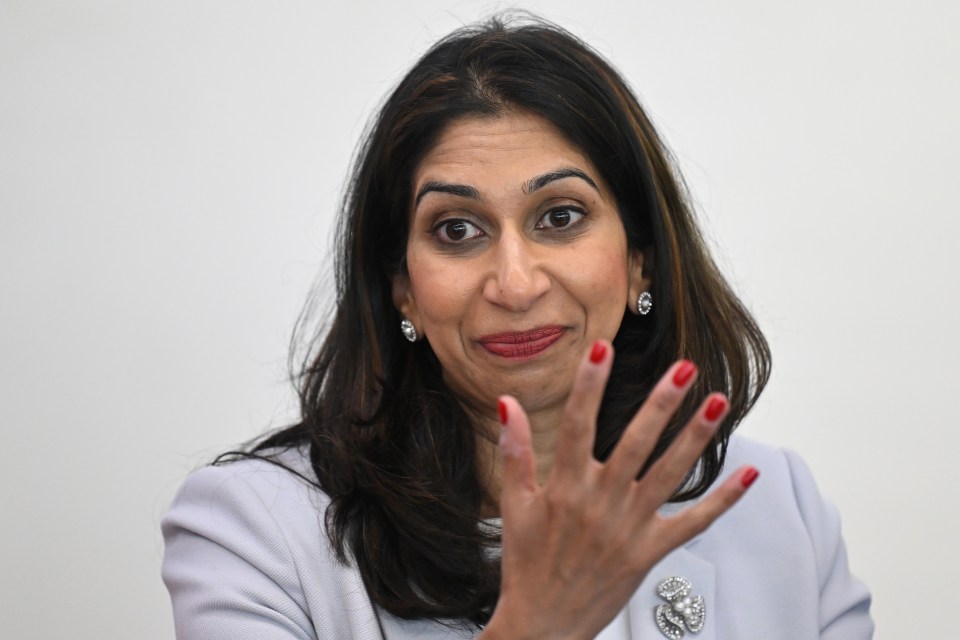 Home Secretary Suella Braverman speaks to volunteers during a visit to Bolton Lads and Girls Club in Bolton, Greater Manchester