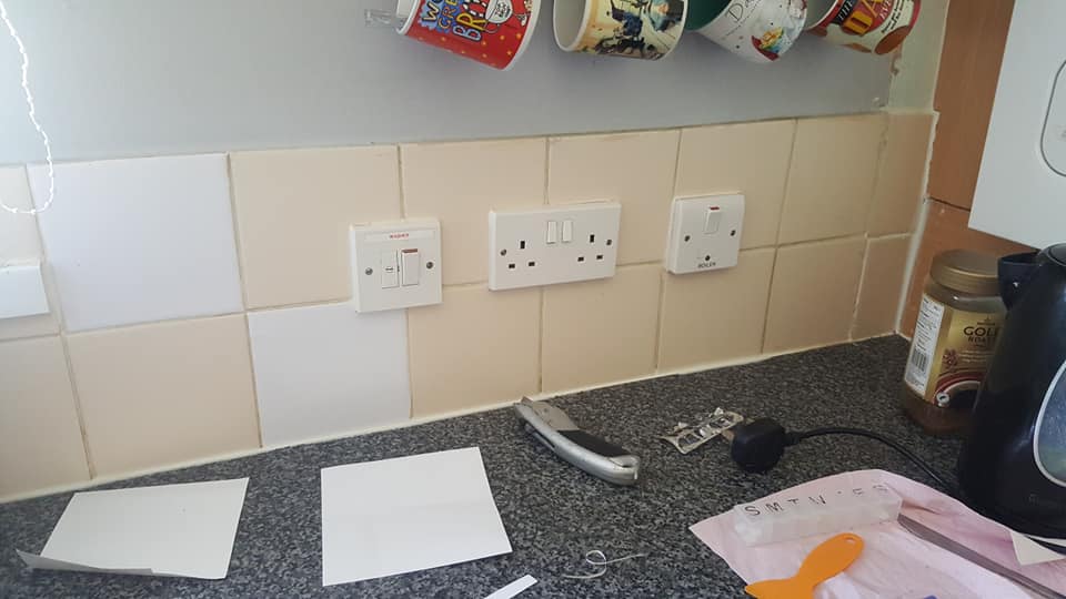 He used stick on wall tiles to transform the dull, cream ones...