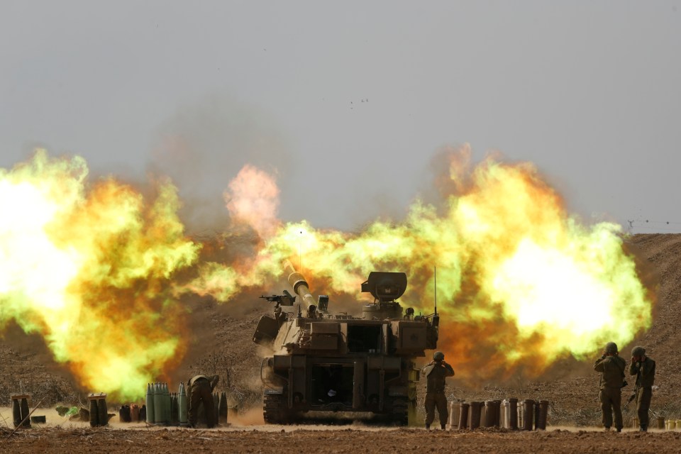 An Israeli artillery unit fires towards Gaza along the border in southern Israel