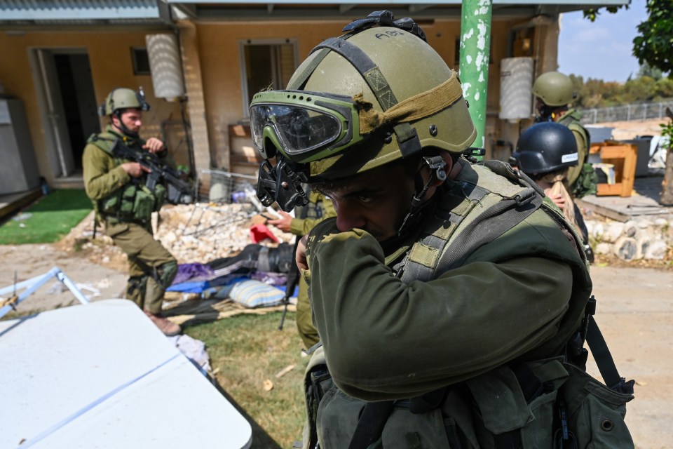 An Israeli soldier struggles with the scenes of horror in the kibbutz of Kfar Aza