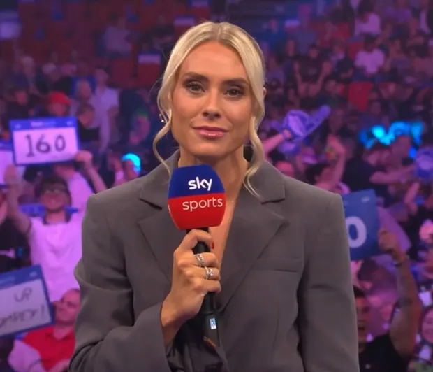 a woman holding a microphone that says sky sports