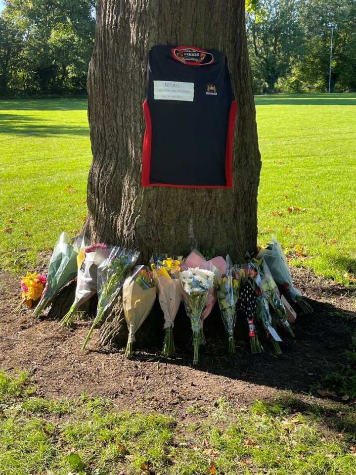 Flowers and a shirt were pinned to a tree in moving tribute at Wisbech Rugby club