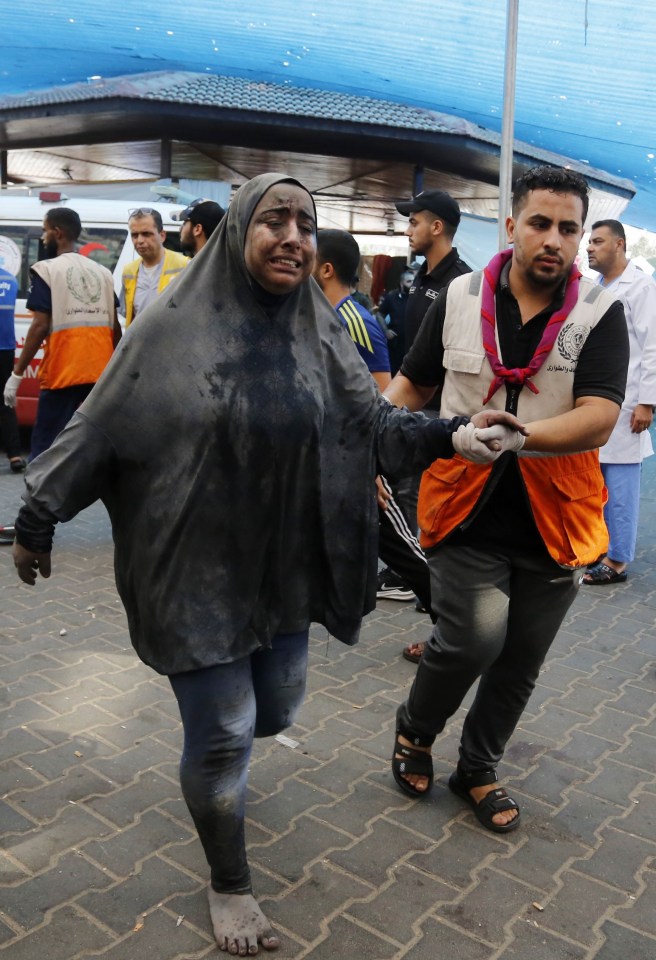 An injured woman is taken to hospital following the Israeli airstrikes