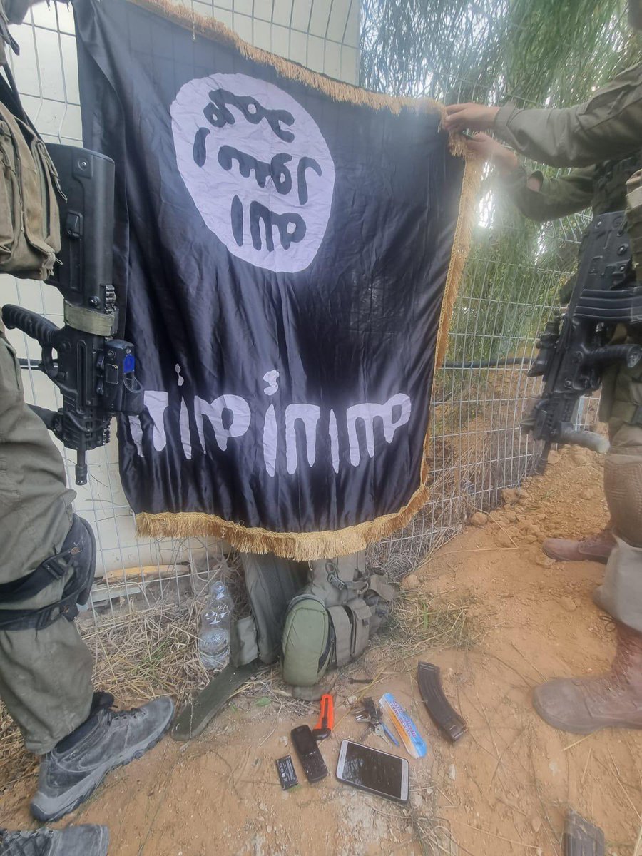 Hamas fanatics hung up an ISIS flag in one kibbutz after storming in