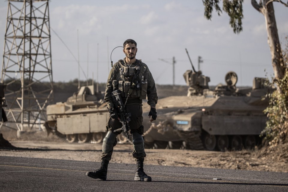 An Israeli soldier stands close to the Gaza border in Netivot