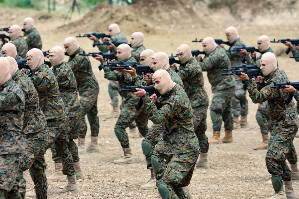 Hezbollah fighters demonstrate military maneuvers during a press tour in the southern Lebanese village of Aaramta