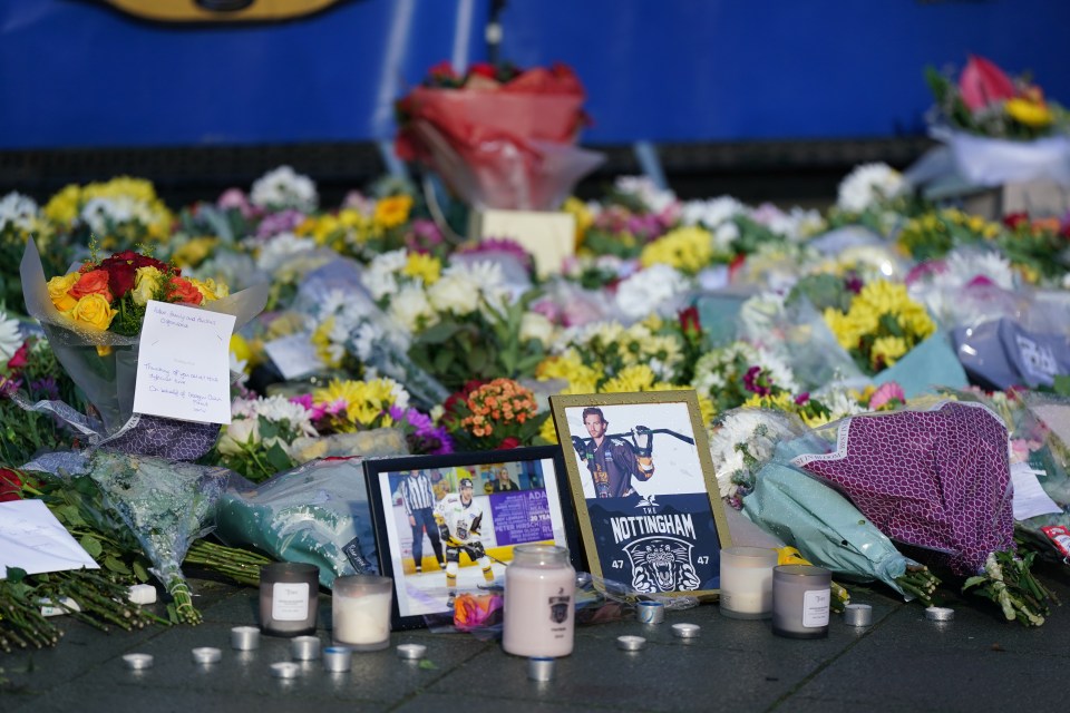 Lit candles among the flowers and messages left in tribute to Johnson outside the Motorpoint Arena in Nottingham