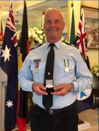 His brother Rick Adderley with the medal