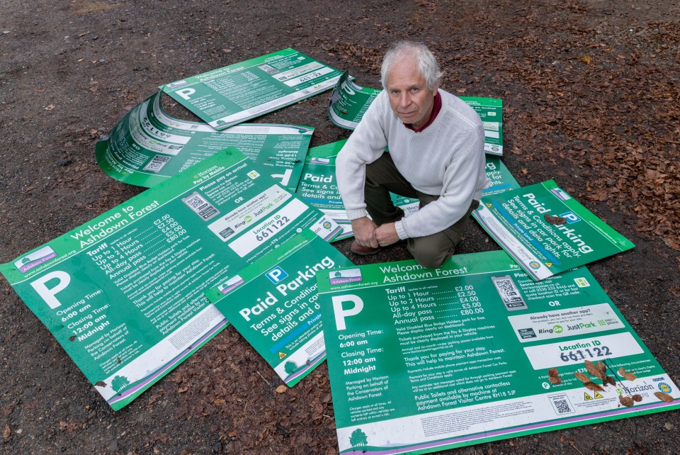 Landscape Recovery Manager Mark Infield with signs that have been ripped off an thrown into bushes