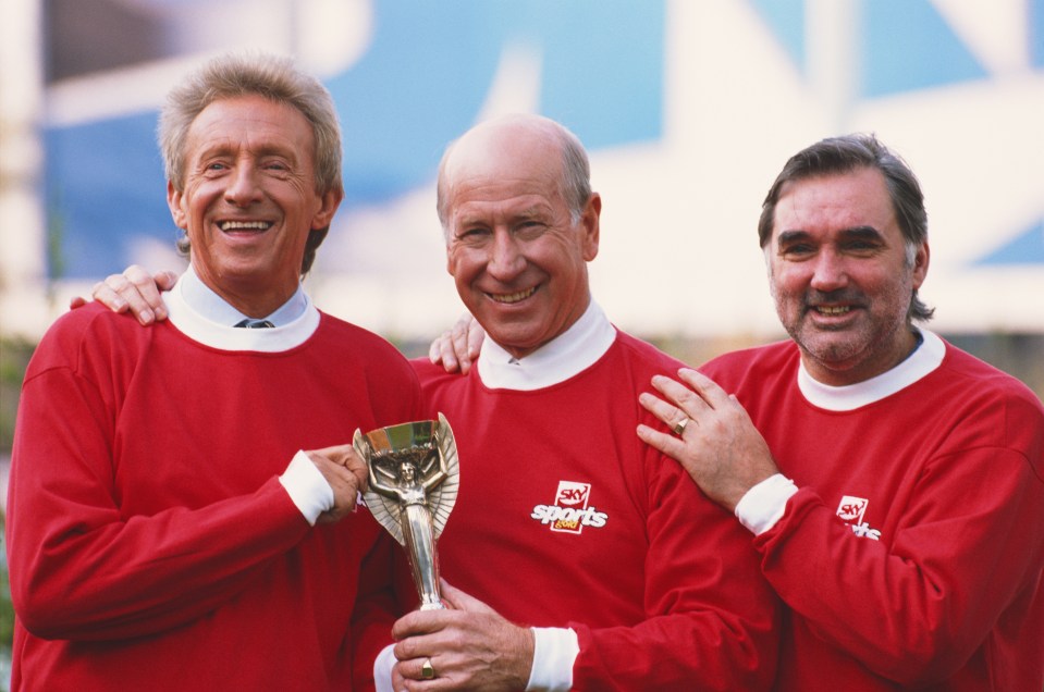 Manchester United legends Denis Law, Bobby Charlton, and George Best holding a trophy.