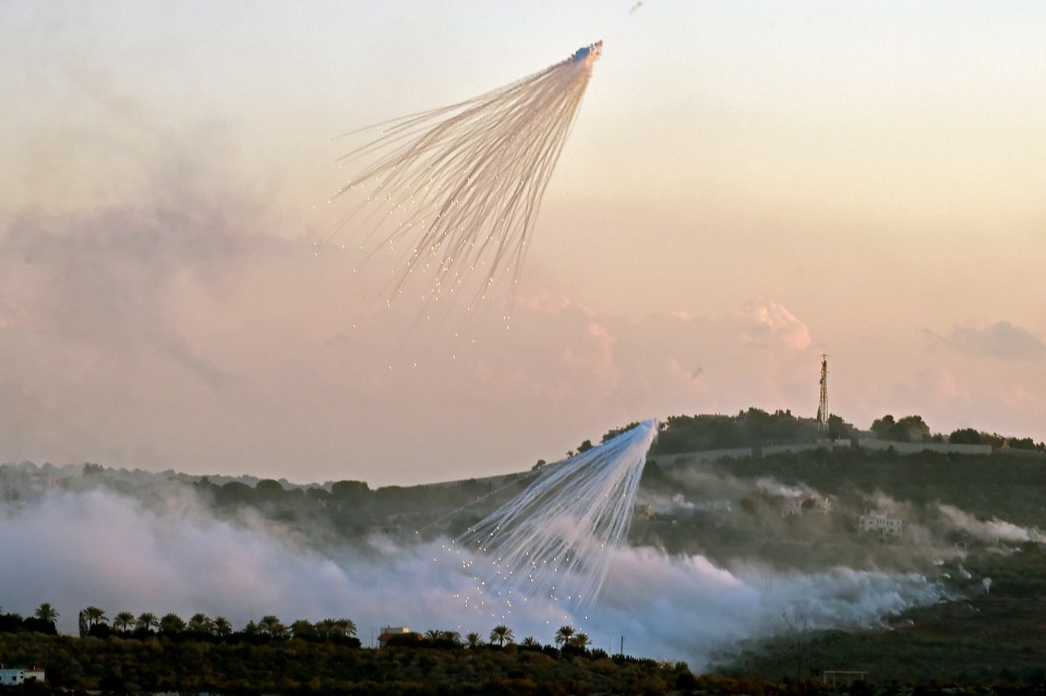 Shells from Israeli artillery explode over Dhayra village, near the Lebanese-Israeli border