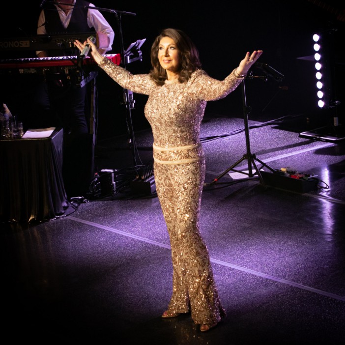 Jane wowed in a skintight gold sequin jumpsuit on stage