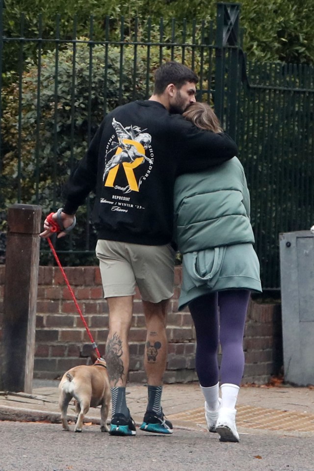 Adam gave Laura a kiss on the head as they walked her dog